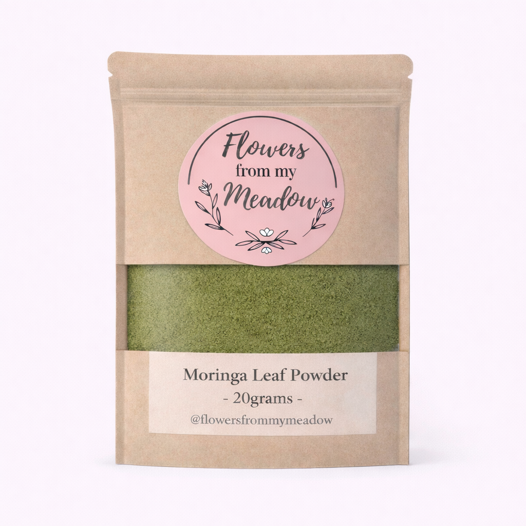 Kraft paper packaging of Moringa Leaf Powder with a pink label on a white background