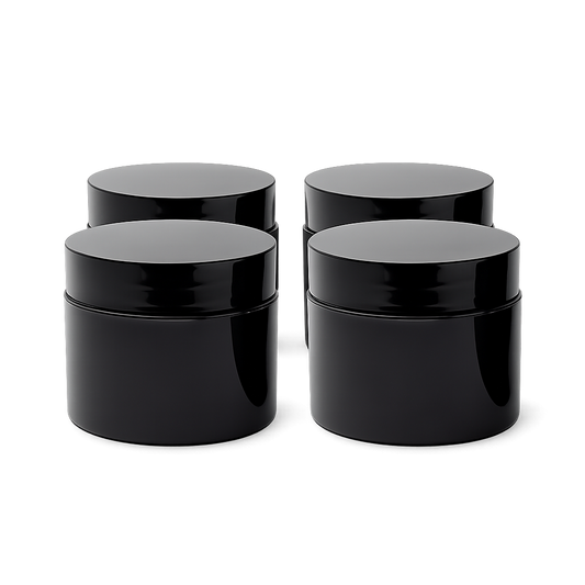 Four black plastic jars with lids on a white background