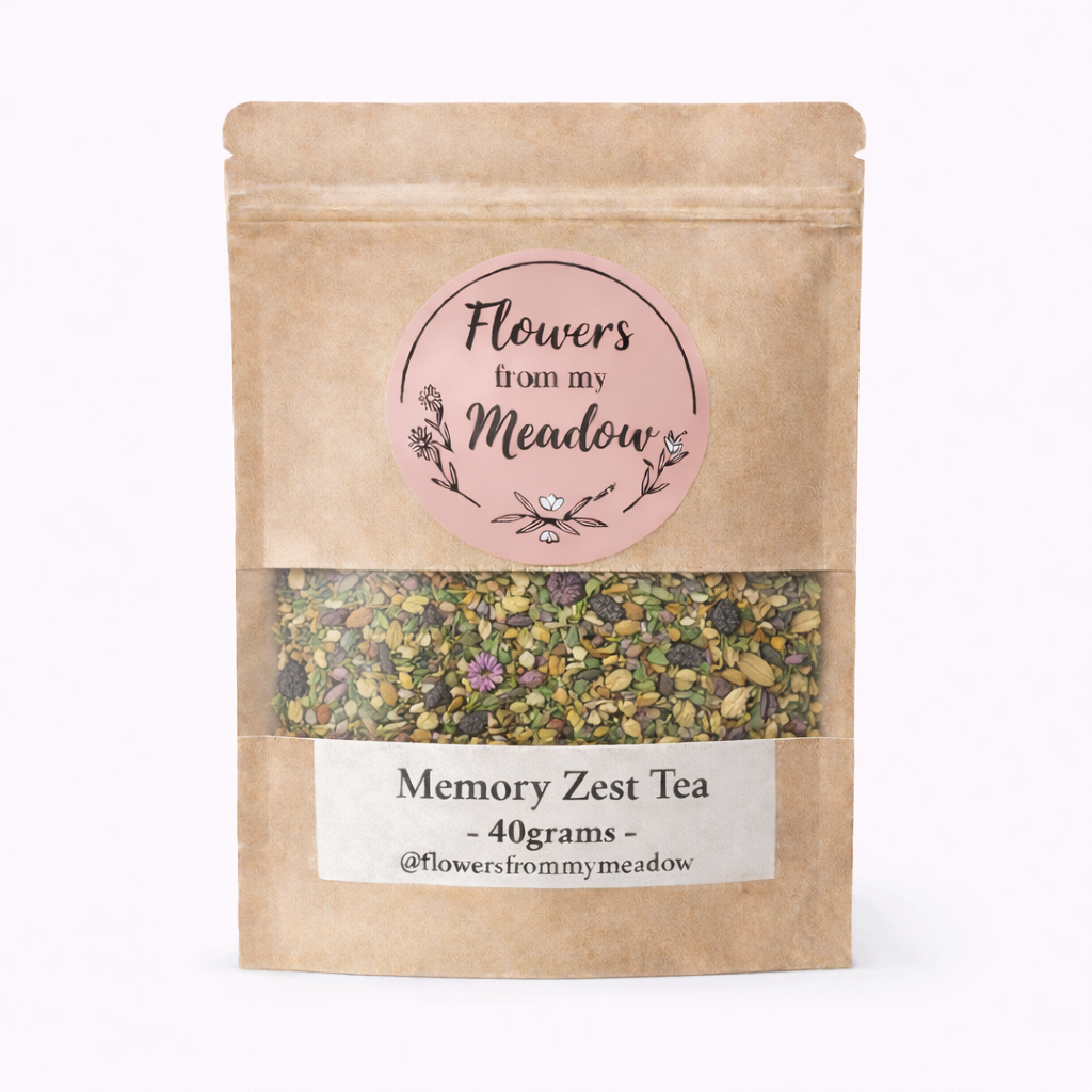 Kraft paper tea bag with 'Flowers from my Meadow' label and tea contents on a white background