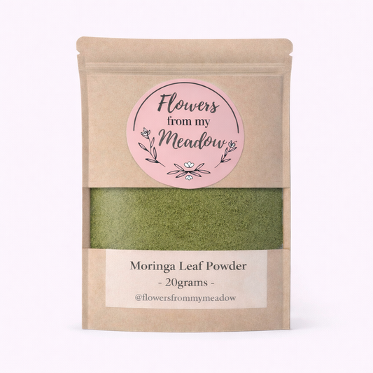 Kraft paper packaging of Moringa Leaf Powder with a pink label on a white background