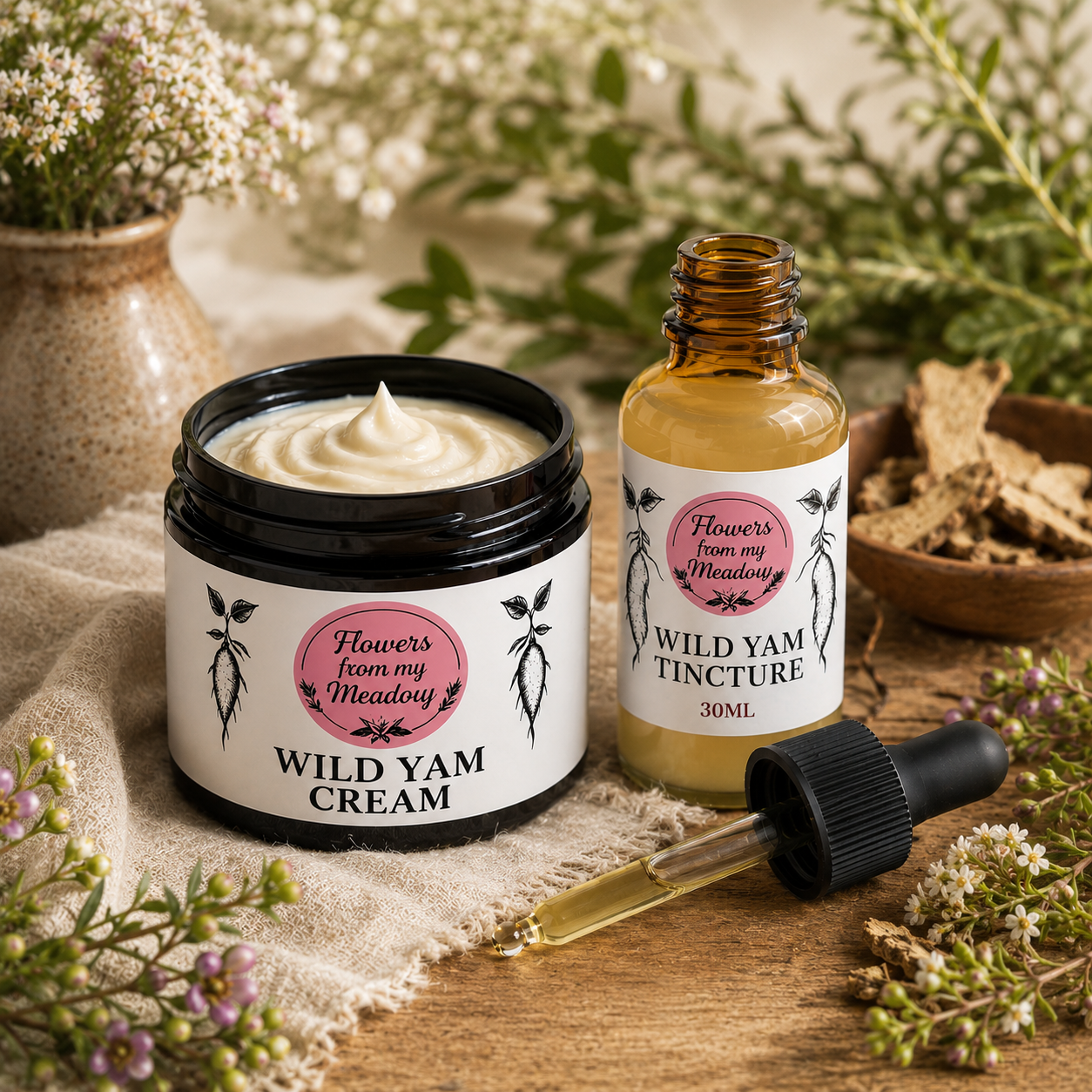 A jar of Wild Yam Cream and a bottle of Wild Yam Tincture with an attached dropper, styled on a rustic wooden surface with dried flowers, herbs, and a ceramic vase in the background. The labels read 'Flowers from my Meadow' and 'WILD YAM CREAM' / 'WILD YAM TINCTURE 30ML'.