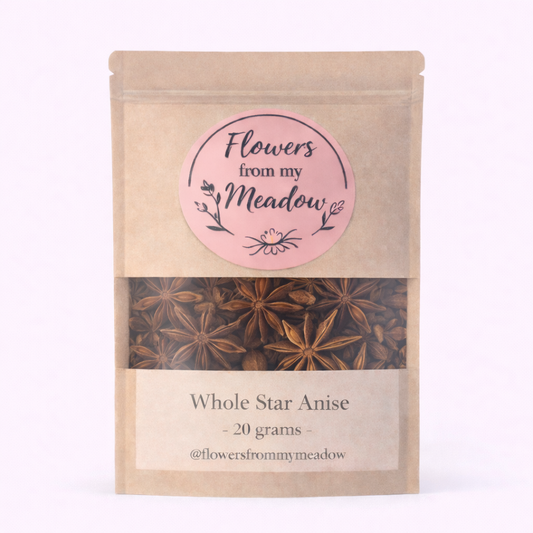 Kraft paper packaging with star anise and a pink label on a white background