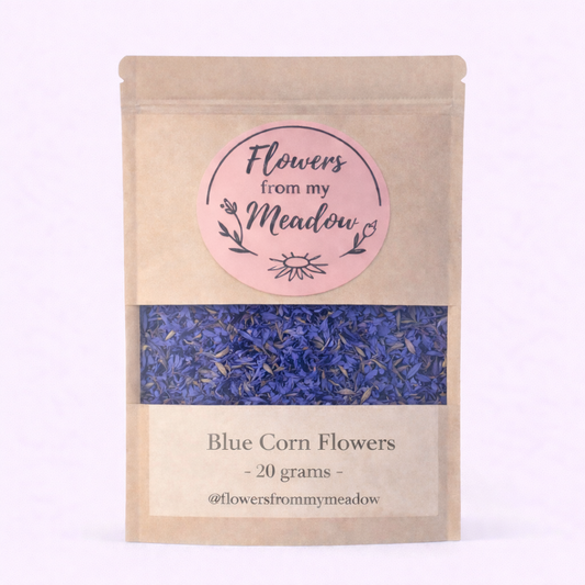 Kraft paper packaging with blue corn flowers and 'Flowers from my Meadow' label on a light pink background