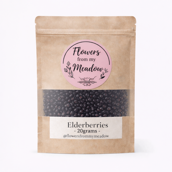Kraft paper packaging with pink label containing elderberries on a white background