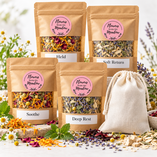 Flowers from my Meadow Restorative Botanical Soak collection featuring four botanical bath tea blends, Held, Soft Return, Soothe and Deep Rest, in labelled kraft pouches with the pink round brand logo, plus a reusable cotton drawstring bath bag.