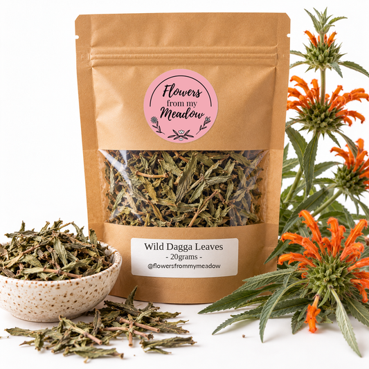 Flowers from my Meadow Wild Dagga Leaves 20g in a resealable kraft pouch with original round pink logo and white product label, with dried olive-green leaves visible through the clear window, beside orange Leonotis leonurus flowers and a bowl of dried leaves.