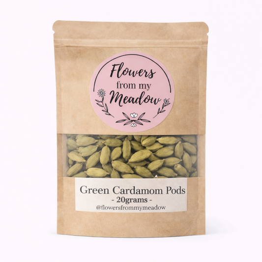Kraft paper packaging with green cardamom pods and 'Flowers from my Meadow' label on a white background