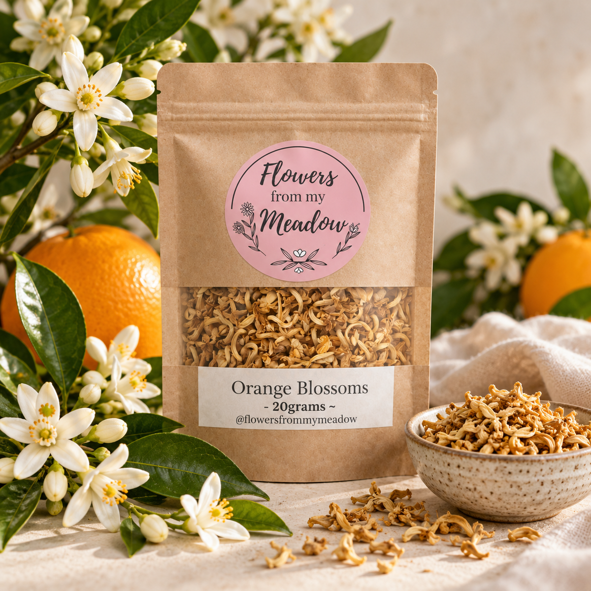 Orange Blossoms 20 g resealable kraft pouch with dried citrus blossoms, styled with fresh white orange blossoms, green citrus leaves and oranges