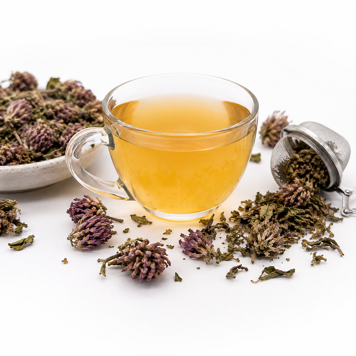 Red Clover tea prepared from dried Trifolium pratense blossoms in a clear glass cup